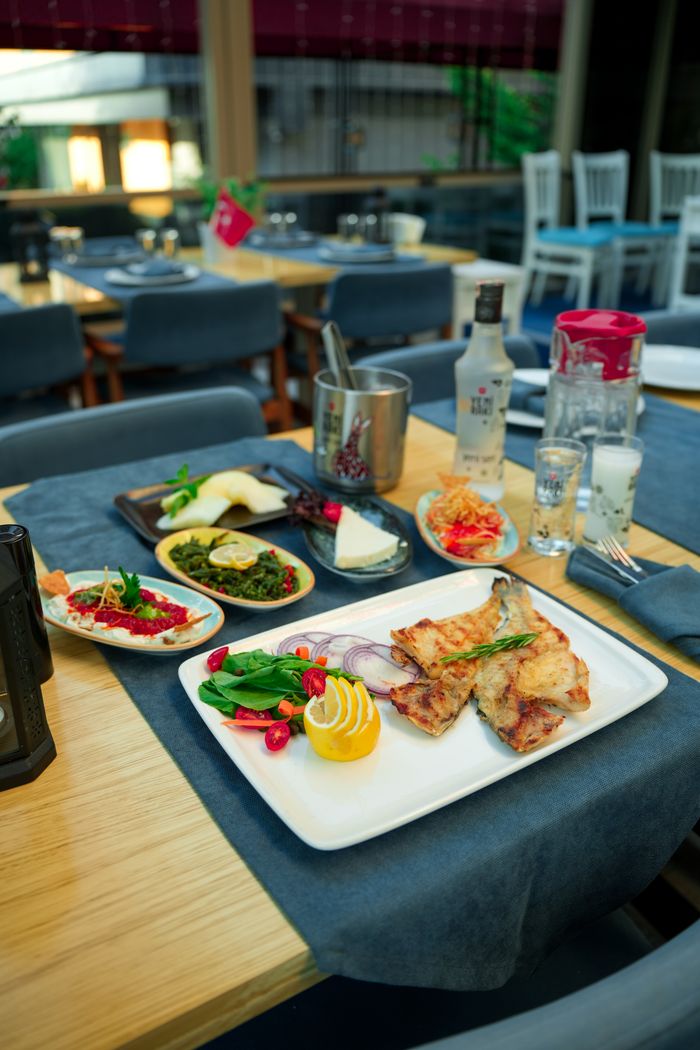 our-story A well-arranged restaurant table showcasing a variety of gourmet dishes, ready for a delightful dining experience.