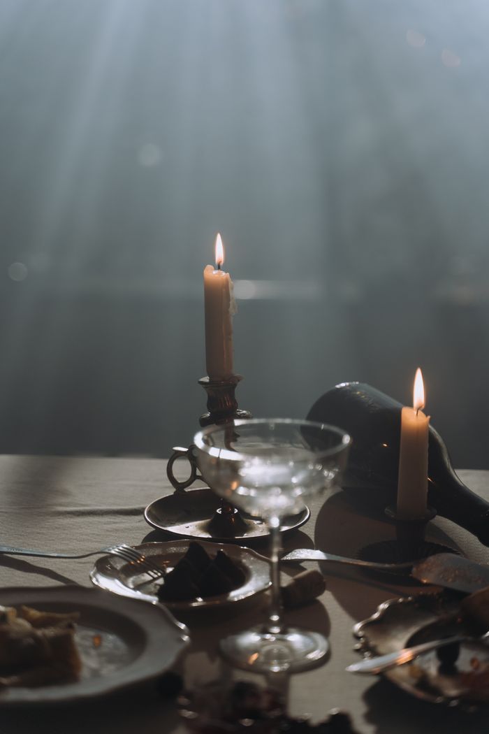 vision Charming candlelit dinner table with elegant tableware and ambient lighting setting a warm mood.